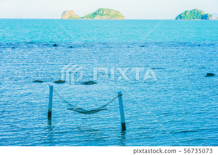 Empty hammock around beautiful beach sea ocean for relax in holiday vacation 56735073