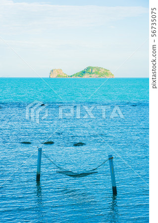 Empty hammock around beautiful beach sea ocean for relax in holiday vacation 56735075