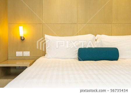 Beautiful white pillow and blanket on bed decoration interior Beautiful white pillow and blanket on bed decoration interior 56735434