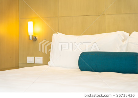 Beautiful white pillow and blanket on bed decoration interior Beautiful white pillow and blanket on bed decoration interior 56735436