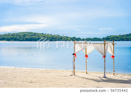 Beautiful outdoor tropical beach sea ocean with umbrella chair and lounge deck around there on white cloud blue sky Beautiful outdoor tropical beach sea ocean with umbrella chair and lounge deck around there on white cloud blue sky 56735442