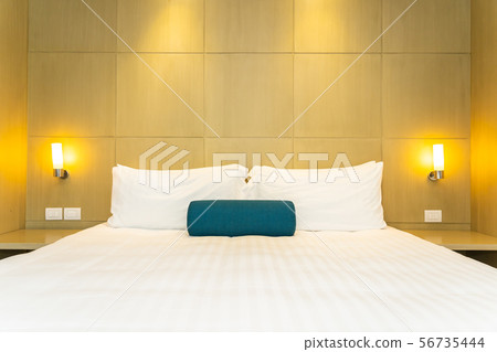 Beautiful white pillow and blanket on bed decoration interior Beautiful white pillow and blanket on bed decoration interior 56735444