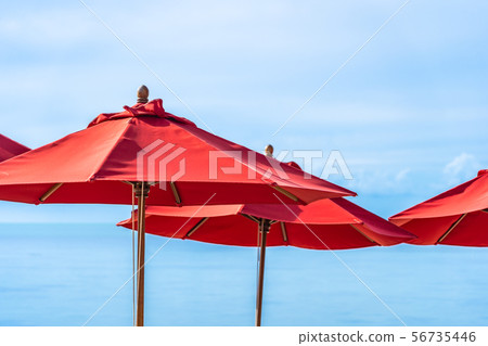 Beautiful outdoor tropical beach sea ocean with umbrella chair and lounge deck around there on white cloud blue sky Beautiful outdoor tropical beach sea ocean with umbrella chair and lounge deck around there on white cloud blue sky 56735446