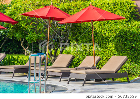Beautiful umbrella and chair around outdoor swimming pool in hotel resort for holiday vacation travel Beautiful umbrella and chair around outdoor swimming pool in hotel resort for holiday vacation travel 56735559