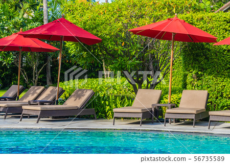 Beautiful umbrella and chair around outdoor swimming pool in hotel resort for holiday vacation travel Beautiful umbrella and chair around outdoor swimming pool in hotel resort for holiday vacation travel 56735589
