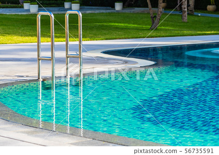Beautiful umbrella and chair around outdoor swimming pool in hotel resort for holiday vacation travel Beautiful umbrella and chair around outdoor swimming pool in hotel resort for holiday vacation travel 56735591