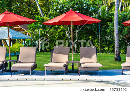 Beautiful umbrella and chair around outdoor swimming pool in hotel resort for holiday vacation travel Beautiful umbrella and chair around outdoor swimming pool in hotel resort for holiday vacation travel 56735592