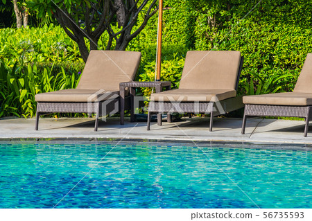 Beautiful umbrella and chair around outdoor swimming pool in hotel resort for holiday vacation travel 56735593