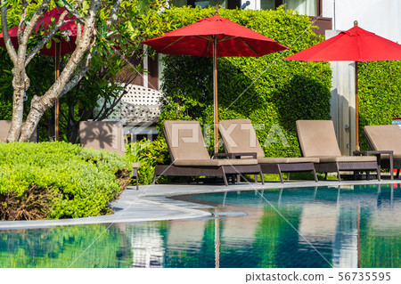 Beautiful umbrella and chair around outdoor swimming pool in hotel resort for holiday vacation travel Beautiful umbrella and chair around outdoor swimming pool in hotel resort for holiday vacation travel 56735595