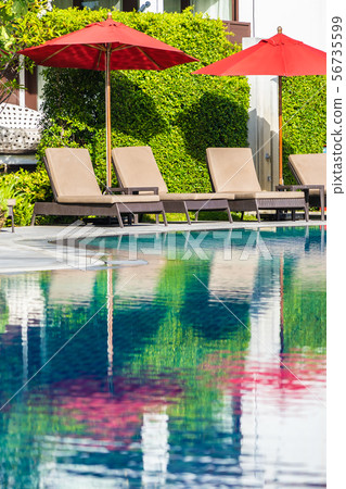 Beautiful umbrella and chair around outdoor swimming pool in hotel resort for holiday vacation travel Beautiful umbrella and chair around outdoor swimming pool in hotel resort for holiday vacation travel 56735599