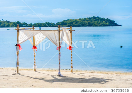 Beautiful outdoor tropical beach sea ocean with umbrella chair and lounge deck around there on white cloud blue sky Beautiful outdoor tropical beach sea ocean with umbrella chair and lounge deck around there on white cloud blue sky 56735936