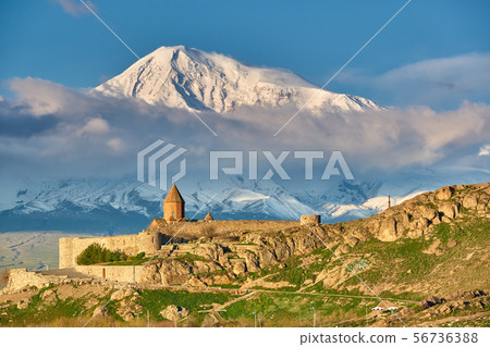 Ancient monastery in front of mountain 56736388