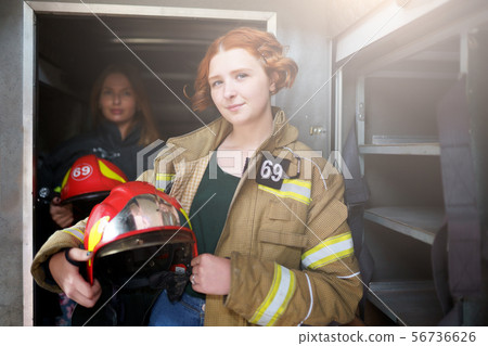 Image of two female firefighters in fire truck Image of two female firefighters in fire truck 56736626