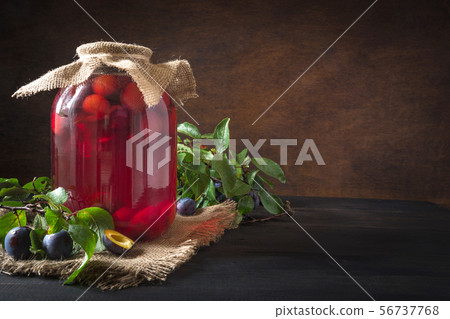 Homemade canned plum compote in large jar . Homemade canned plum compote in large jar . 56737768