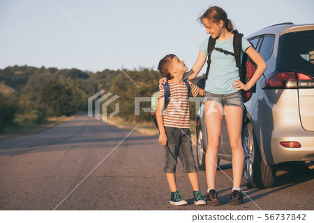 Happy brother and his  sister are standing near 56737842
