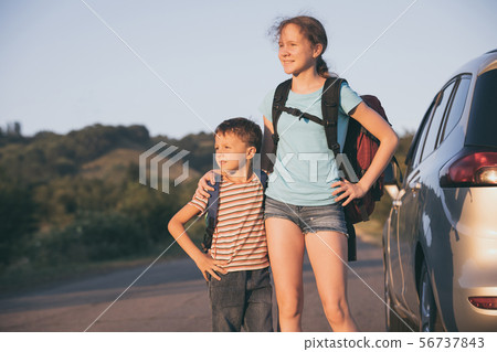 Happy brother and his  sister are standing near 56737843