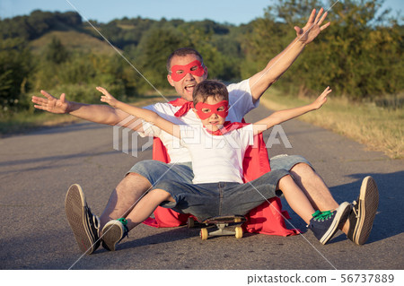 Father and son playing superhero at the day time. Father and son playing superhero at the day time. 56737889