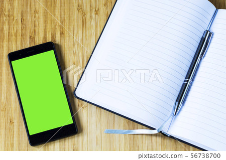 mobile smartphone with green screen and notepad 56738700
