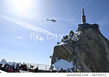 Tourists looking at the material transport edge of the Aiguille du Midi observatory repair work 56739171
