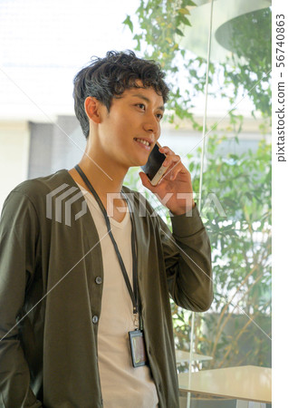 A man talking on a cell phone 56740863