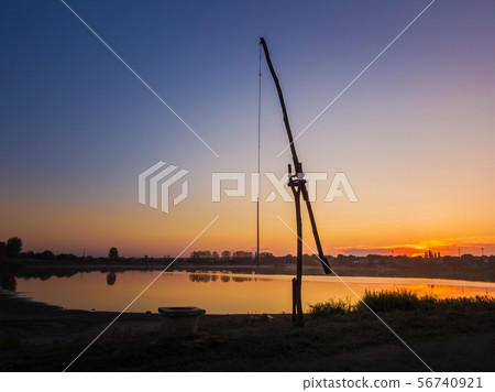 Idyllic rural scene with an old water well Idyllic rural scene with an old water well 56740921