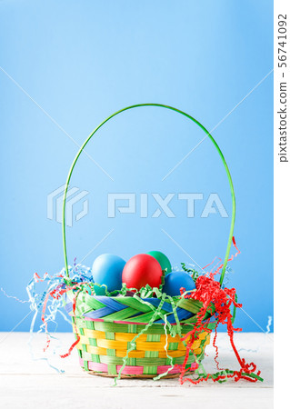 Photo of basket with colorful eggs Photo of basket with colorful eggs 56741092