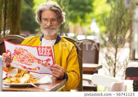 Man in the street cafe preparing for his walk. 56741123