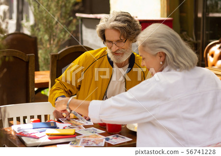 Husband and wife looking for the best picture from their travel. Husband and wife looking for the best picture from their travel. 56741228