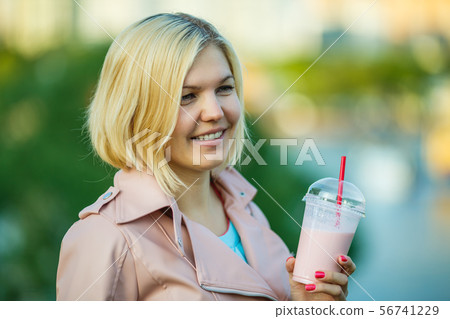Girl with milkshake , defocused background 56741229
