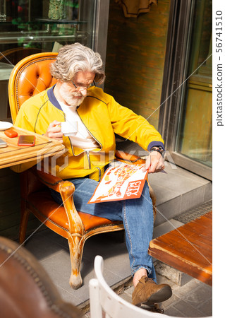 Man drinking his coffee in the street cafe. Man drinking his coffee in the street cafe. 56741510