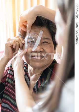 Elderly patient woman having eye care treatment  56742220