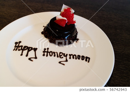 A honeymoon cake isolated on a wooden background A honeymoon cake isolated on a wooden background 56742943