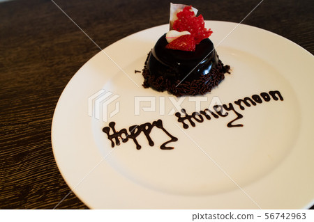 A honeymoon cake isolated on a wooden background A honeymoon cake isolated on a wooden background 56742963