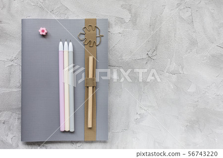 Notebook and pens on a gray background. Notebook and pens on a gray background. 56743220