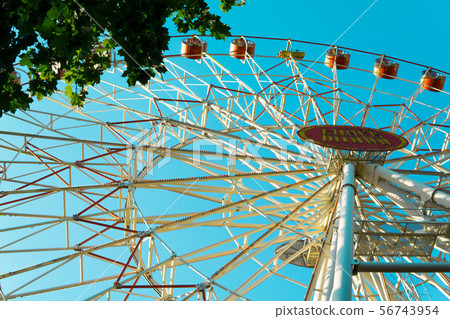 Ferris wheel on the blue sky background. Ferris wheel on the blue sky background. 56743954