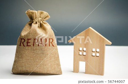 Money bag with the word repair and a wooden house. Money bag with the word repair and a wooden house. 56744007