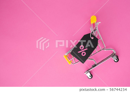 Shopping cart with sale tag on pastel pink Shopping cart with sale tag on pastel pink 56744234
