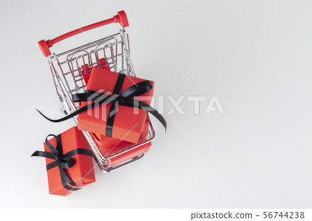 Red gift box with black bow in shopping cart, Red gift box with black bow in shopping cart, 56744238