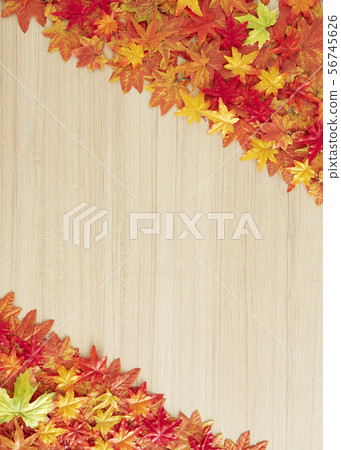 Autumn leaves on a wooden table 56745626