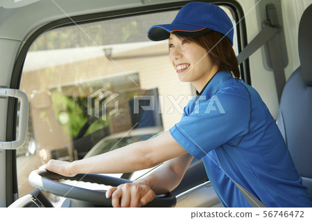 Female truck driver driving Female truck driver driving 56746472
