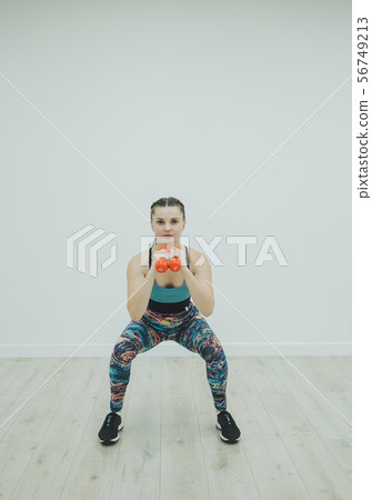 woman in sportswear doing squat woman in sportswear doing squat 56749213