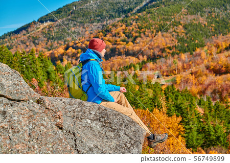 Backpacker man at Artist's Bluff in autumn 56749899