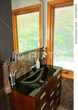 Black wash-basin at the window in a bathroom of luxury house. 56749955