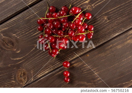 Fresh red currant on brown wood Fresh red currant on brown wood 56750216