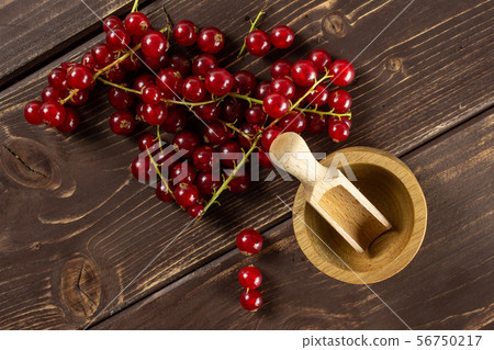 Fresh red currant on brown wood Fresh red currant on brown wood 56750217