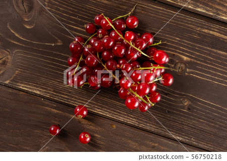 Fresh red currant on brown wood Fresh red currant on brown wood 56750218