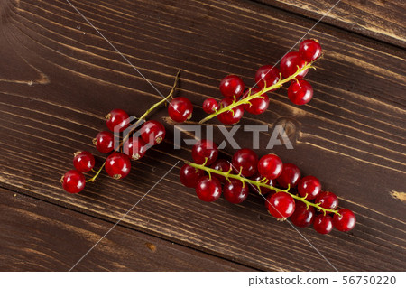 Fresh red currant on brown wood Fresh red currant on brown wood 56750220