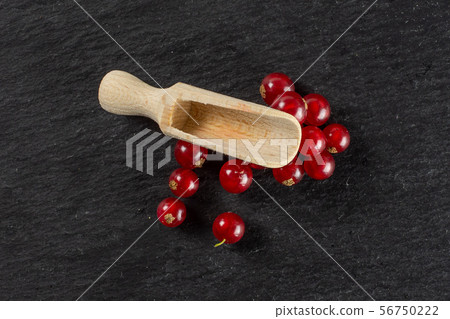 Fresh red currant on grey stone Fresh red currant on grey stone 56750222
