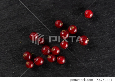 Fresh red currant on grey stone Fresh red currant on grey stone 56750225