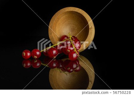 Fresh red currant isolated on black glass Fresh red currant isolated on black glass 56750228